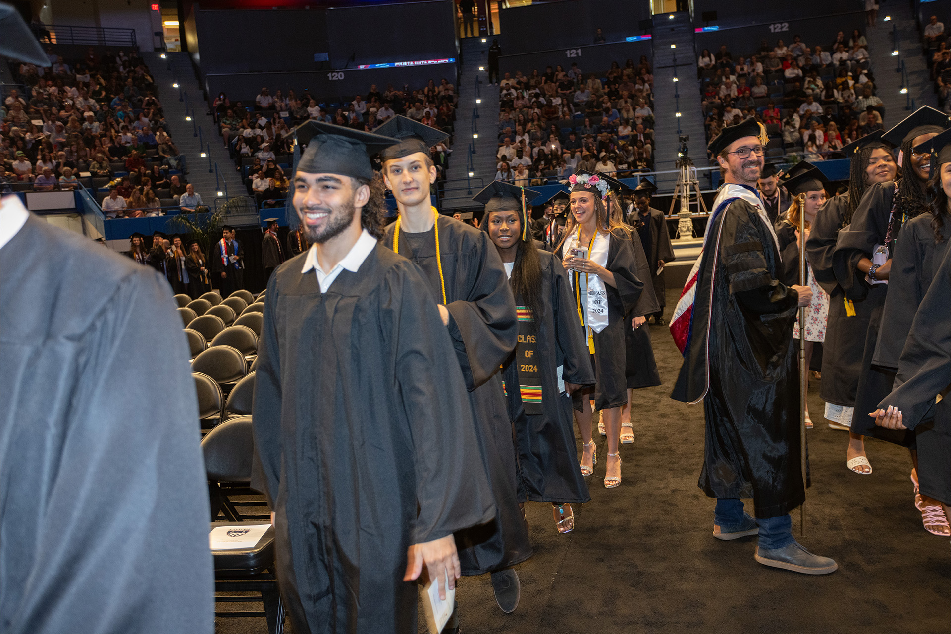 Graduates walking down the aisle to their seats
