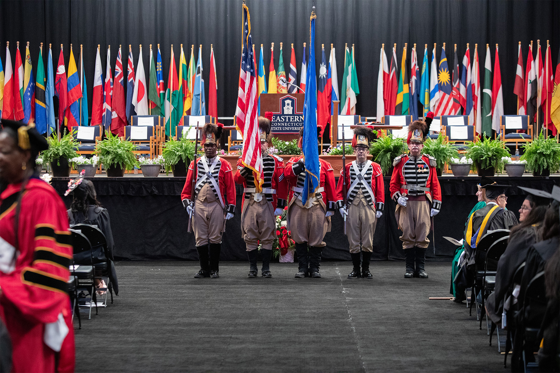 the Govenor's Foot Guard standing in front of the Commencement stage