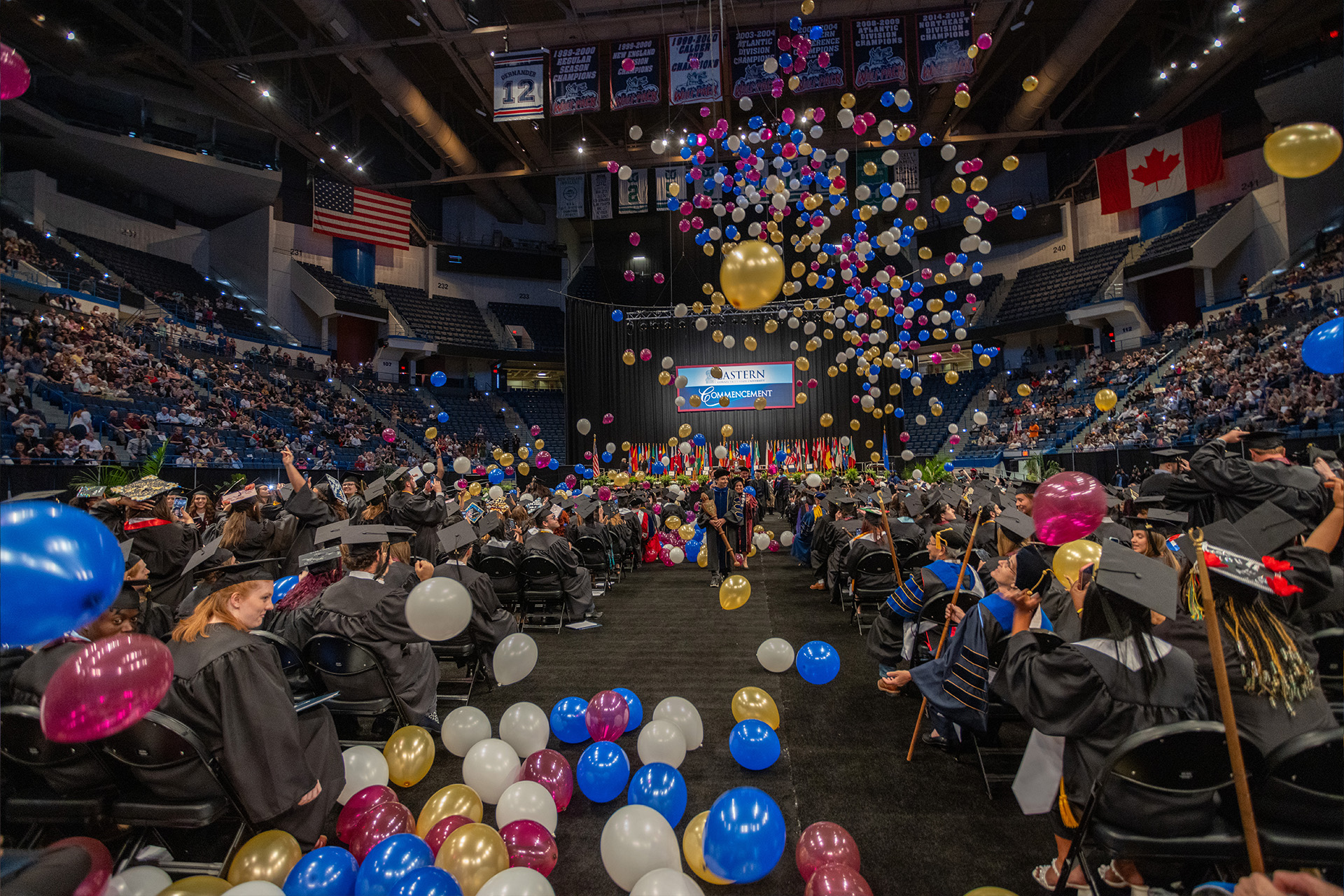Colorful balloons falling from the ceiling as Commencement ends