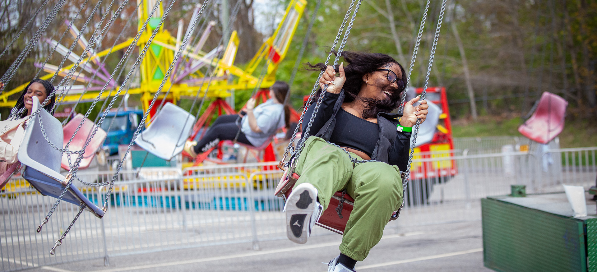 student enjoying the swinging chairs carnival ride