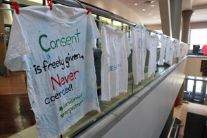 Clothesline project t-shirts displayed with t-shirts that show support for interpersonal violence awareness.