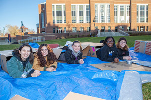 Student's who volunteered to sleep in the cold pose for a photo.