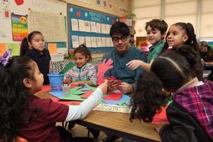 An Eastern student facilitates the hand decoration station.