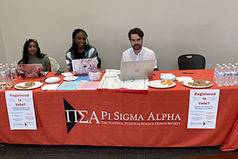 Pi Sigma Alpha students table for voter registration