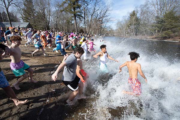 students taking the 'Plunge for Hunger' into a cold river