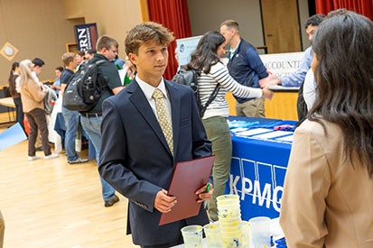 A student networking with a prospective employer at the Accounting Fair