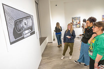 Students gather at the Fine Arts Instructional Center Art Gallery for the biennial art and design faculty exhibition