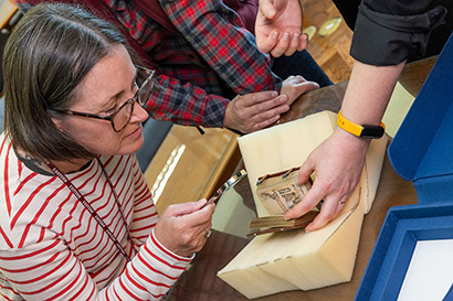 An open house participant examines the facsimile book of hours