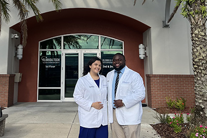 Jolie Garcia and Sajae Willis at their White Coat ceremony at Burrell College of Osteopathic Medicine Florida Campus in Melbourne on July 2025