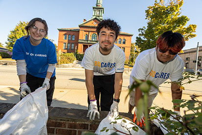 Students clean Main Street in front of the Windham Town Hall
