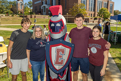 A family poses with Willi the Warrior