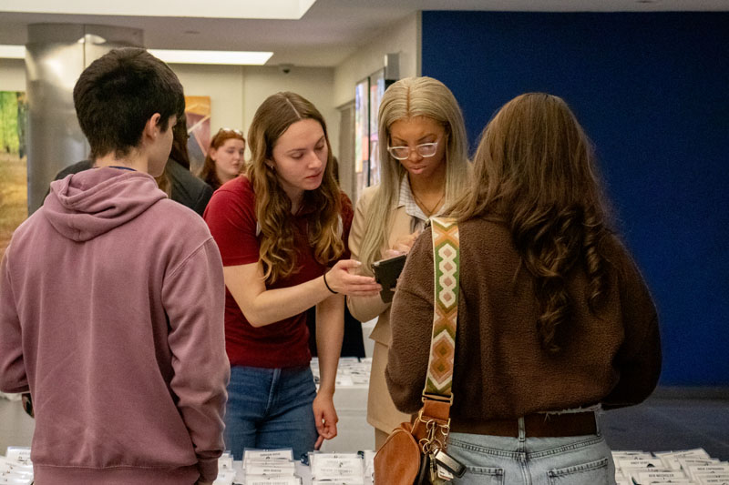 Admissions staff help accepted students sign in