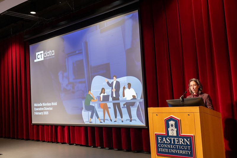 Eastern’s latest “University Hour” discussion featured Michelle Riordan-Nold, executive director of the Connecticut Data Collaborative (CTData). The discussion took place at the Student Center Theatre on Feb. 12 at 3 p.m. and was organized with the help of Garrett Dancik, program coordinator of the applied data science graduate program at Eastern.    CT Data’s mission is to provide data and data support so that nonprofits, state agencies, businesses and the public can make decisions and work toward equity. Riordan-Nold highlighted ways to use data for this work as well as telling CTData’s origin story.      CTData’s beginnings      Riordan-Nold explained how the times have changed; data was once more difficult to access. “(Data) only existed in PDF (files) and government websites, which is not what we consider accessible data,” she said.       As a solution, CT Data envisioned a website where a broad audience could access data through visualization tools. One of their first projects was the Connecticut Racial Profiling Prohibition Project in a partnership with the Insititute for Municipal and Regional Policy.       Riordan-Nold kept working with CT Data to create websites where data was not only available but accessible, but she realized that “(we) can put a lot of data out there, but it doesn’t mean people know how to use it,” she noted.    This led CT Data to launch the Connecticut Data Academy in 2017, where they hold different workshops teaching people how to use data. They also emphasize the importance of data literacy, which is the “ability to systematically and ethically ask and answer real world questions with data,” said Riordan-Nold.    Past projects   In an early project, data on traffic stops was used to obtain the race and ethnicity of drivers, as well as post-stop outcomes, which were studied to discover disparities in the ethnicity of those pulled over and their treatment and send a legislative committee to work with police departments.       A recent project addressed pandemic-era evictions. Federal court records lacked data on sex, race and ethnicity of renters, complicating efforts to determine who is being evicted.   CTData used multiple sources, including the Connecticut Judicial Branch and the Social Security Administration, to estimate defendants' demographics. They also referenced Census Bureau ZIP code data.   Findings showed Hispanic/Latino and Black renters faced the highest eviction rates, with most defendants being female.   CTData’s work was referenced in discussions advocating for the passage of counsel legislation in Connecticut. “The project was rewarding,” said Riordan-Nold. “Sometimes when you do this work, you never know if anybody even cares.”   Using data effectively   Riordan-Nold shared the problem of non-profits collecting data but not making decisions based on it, either because they are not trained in data analysis skills or because they fear what the data is going to show: “There is a problem with people collecting too much but not doing enough.”   Another effort to increase data literacy, specifically in the non-profit sector, led CT Data to launch the social enterprise CTData Strategic Planning. They found that women make up 66% of the non-profit workforce, but only 40% of the non-profit staff say they use data that they collect to make decisions.    “Women are often led to doubt in their abilities in math,” said Riordan-Nold. “These social perceptions about math have influenced participation and confidence levels to use data in the non-profit sector.”  