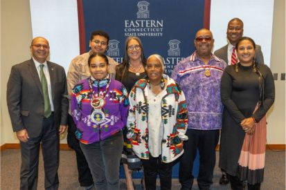 Left to right, back row: President Karim Ismaili, Sebastian Spencer '26 (varied indigenous background and reader of statement), Beth Regan '79, Michael Thomas (Mashantucket Pequot), LaMar Coleman (VP of equity and diversity). Front row: Natasha Gambrell '15 (Eastern Pequot), Valerie Gambrell '77 (Eastern Pequot), Cassandra Sherman Keola (Golden Hill Paugussett)