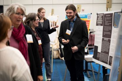Ian Harrington (right) presents to Dean of Arts and Sciences Emily Todd.