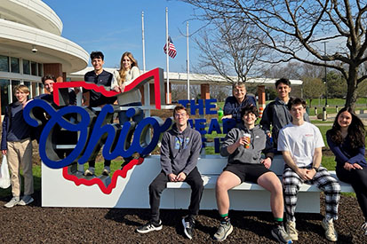 Eastern's BIS-ITSA club poses in front of a State of Ohio sign.