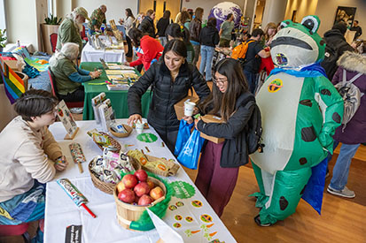 "Earth Day Market" attendees view vendors and exhibitors.