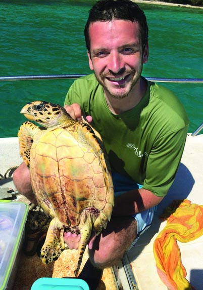 Clay Pollock holding a turtle