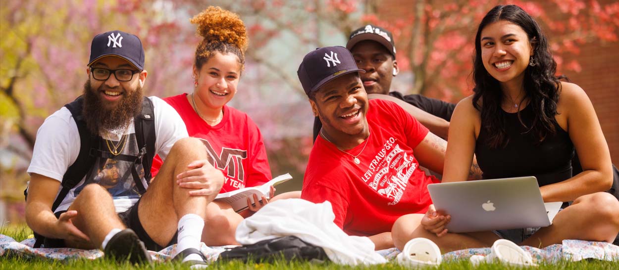 Students laughing while studying outdoors