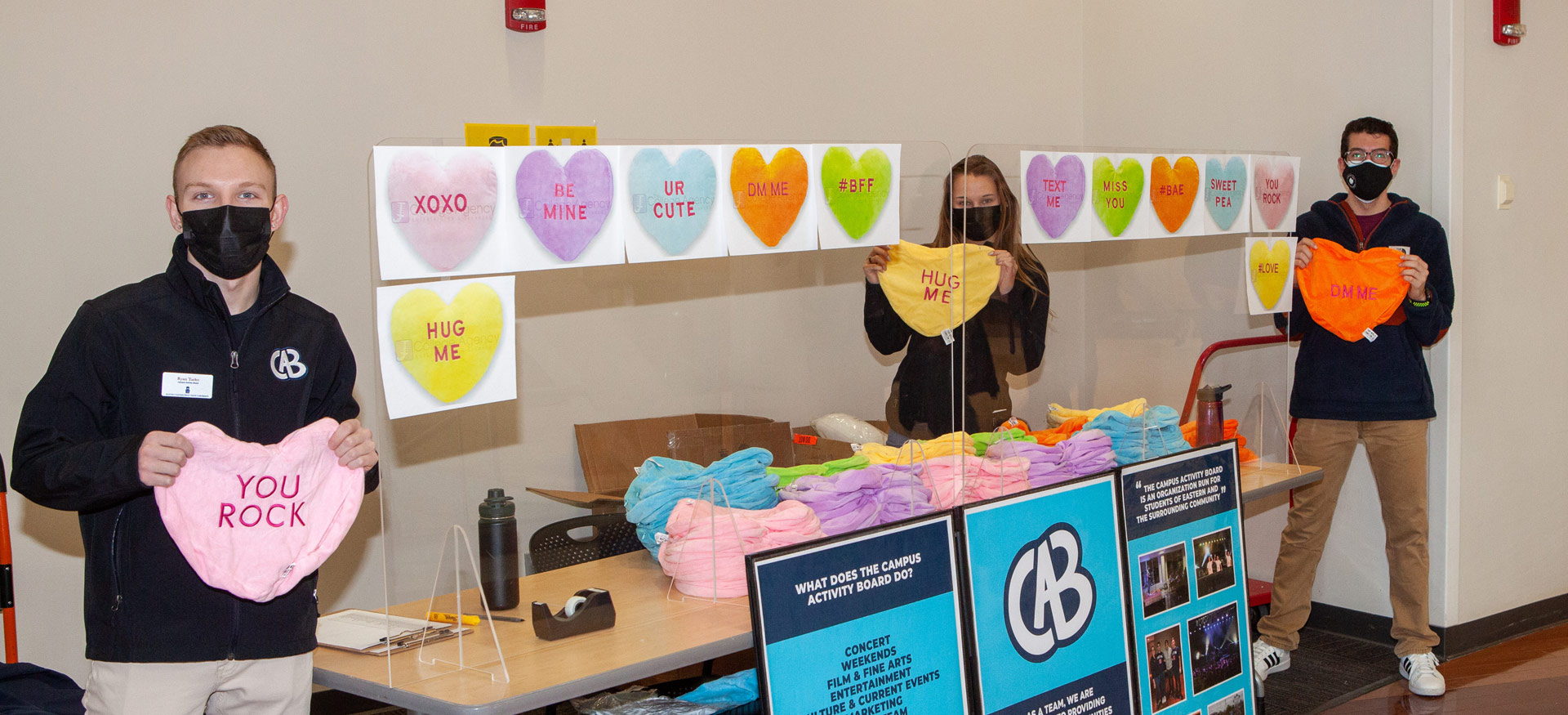 students holding valentine hearts