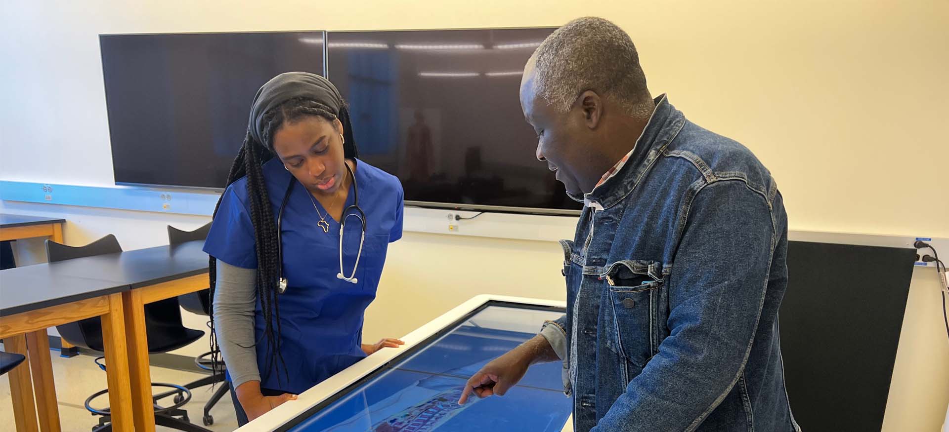 student and professor use dissection table