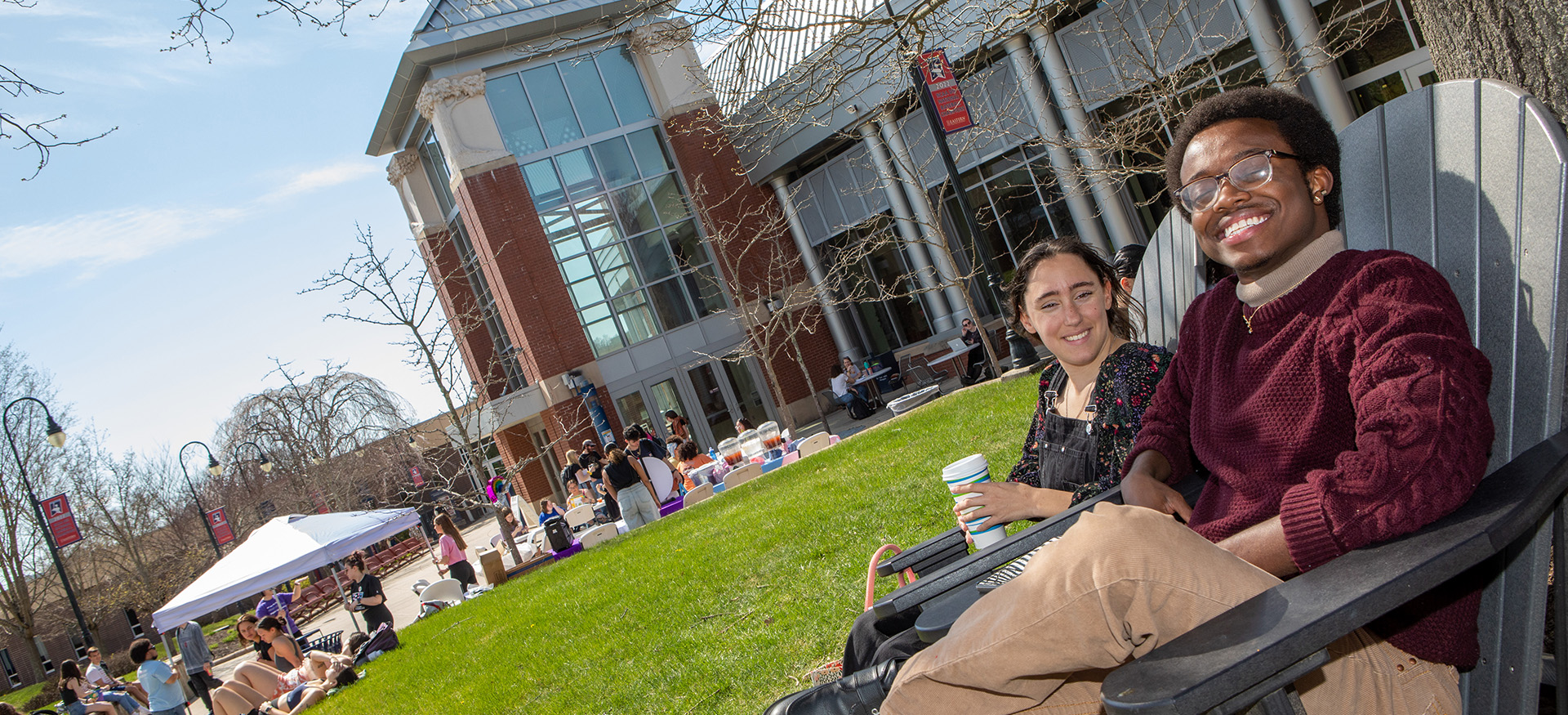 students sitting in front of the student center
