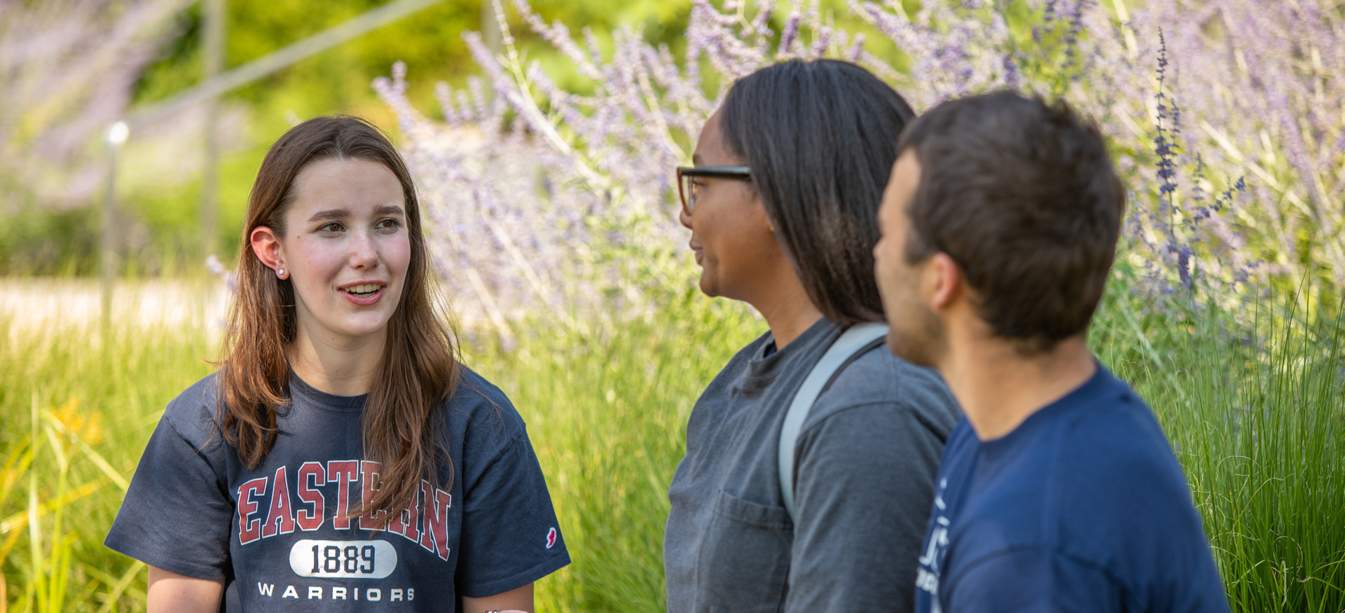 students sitting outdoors talking
