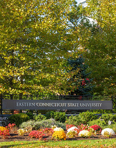 The Eastern entrance sign with flowers in front