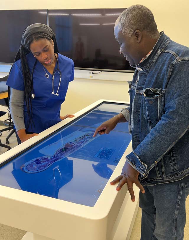 student and professor use dissection table