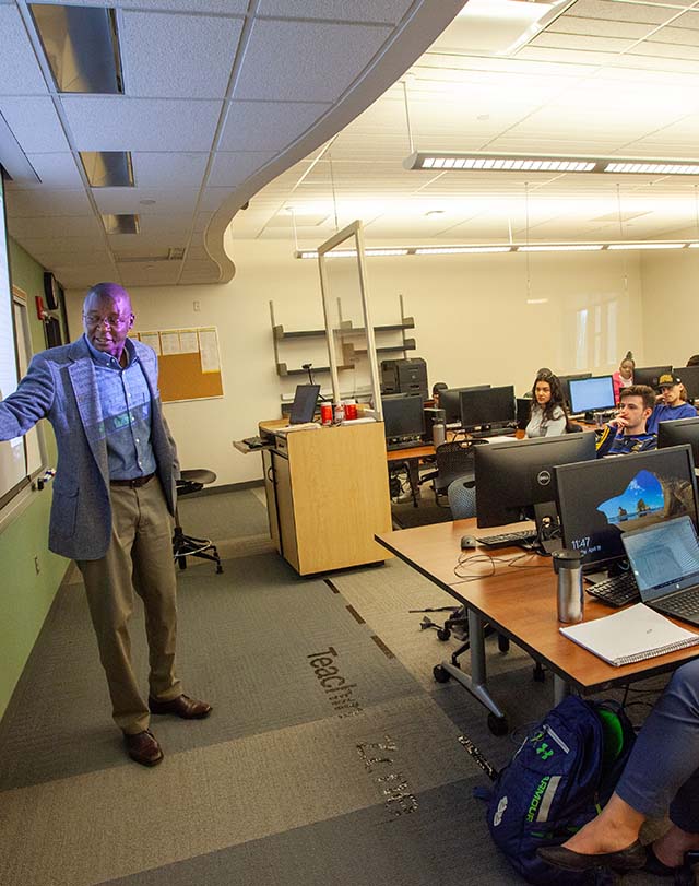 a professor teaching in front of the class