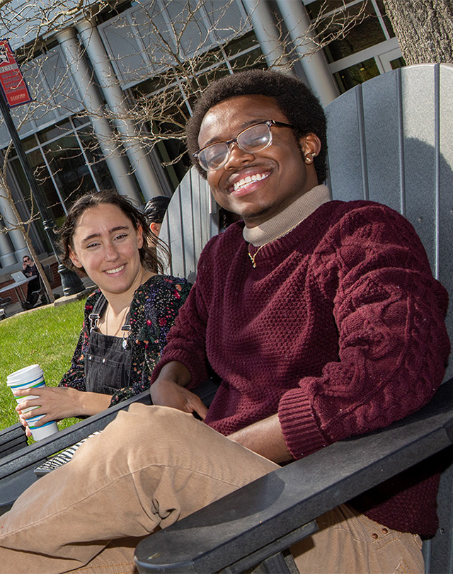 students sitting in front of the student center