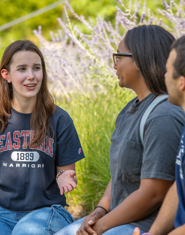 students sitting outdoors talking