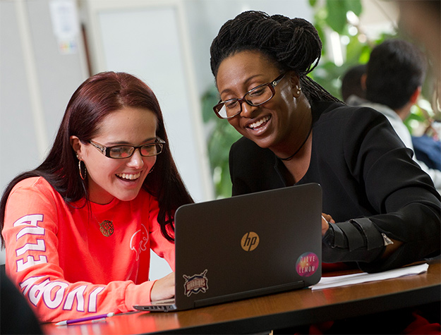 registrar helping student on computer