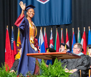 graduate speaker waving during Commencement