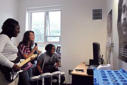 students playing video game in dorm