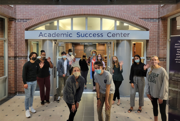 Students posing for photo in front of the Academic Success Center