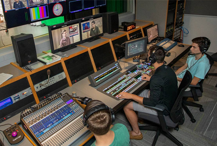 students sitting in a television control booth