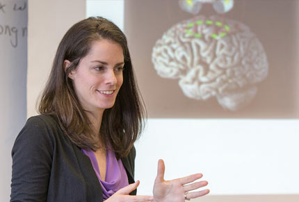 professor teaching in front of projector image