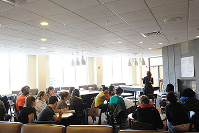 Decorative image of professor teaching a classroom full of students