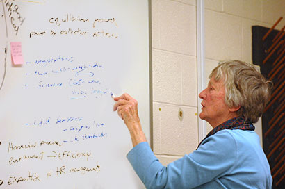 Decorative image of professor writing on a whiteboard