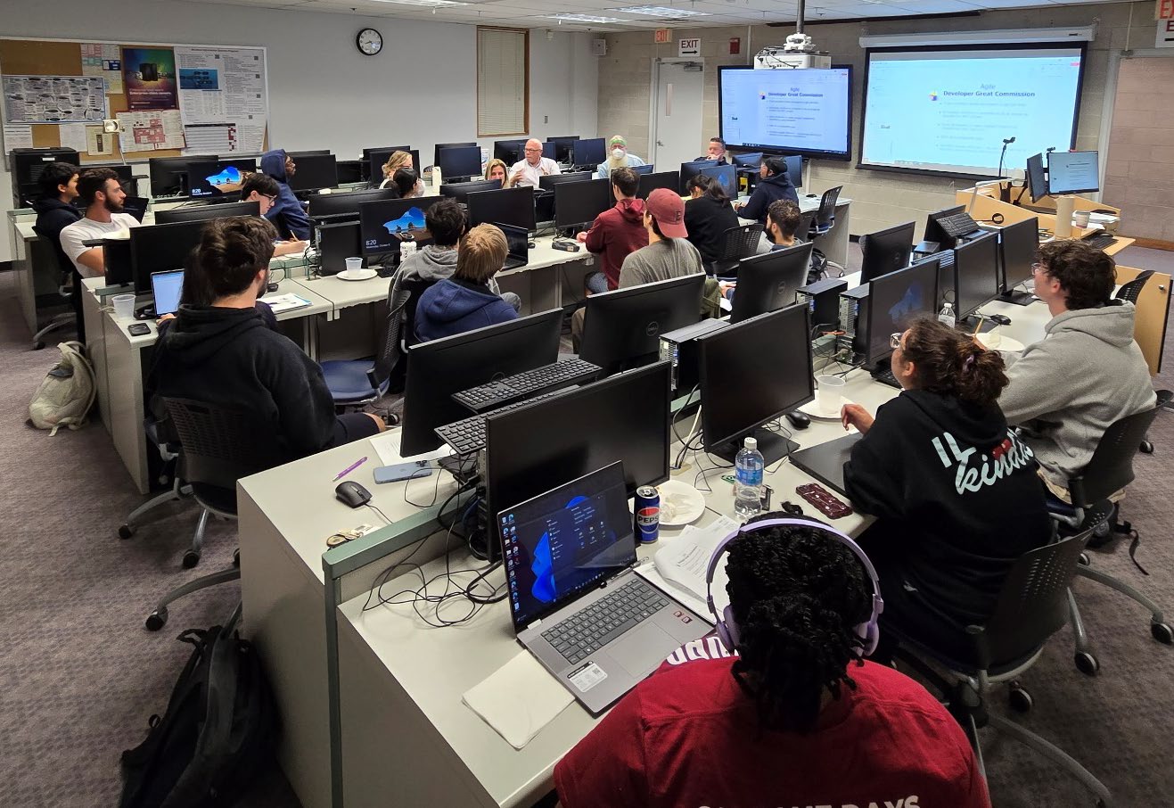 students sitting in front of computers in the classroom