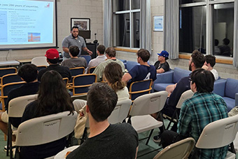 students listening to a presenter 