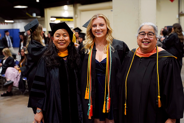 grad posing with faculty