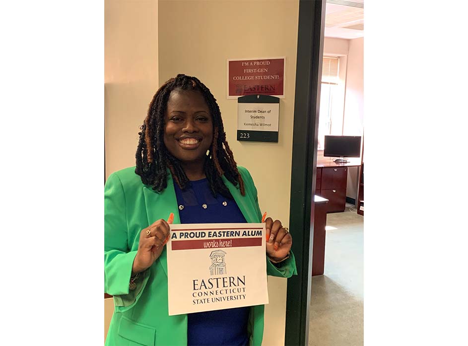 Kamesha, an alumni holding Eastern spirit poster