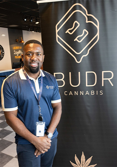 Derrick Gibbs in front of his business banner