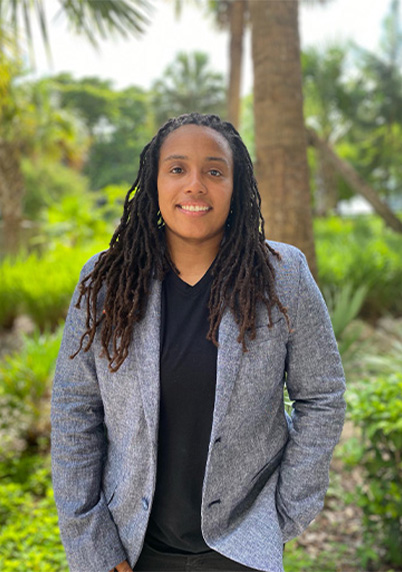 Roc Rochon posing in front of greenery