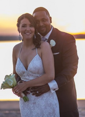 Megan Willis and Kelvin Bush wedding photo in front of a sunset on the beach