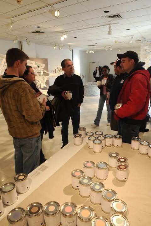 attendees discussing during an Akus Gallery opening