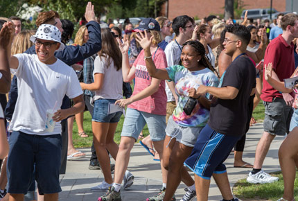 students outdoors greeting each other