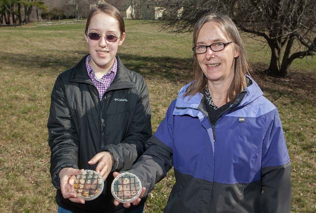 Student and professor outside holding petri dishes